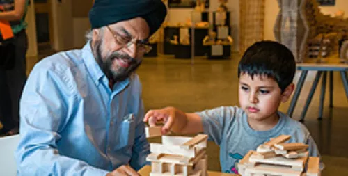 elder and child enjoying use of keva planks