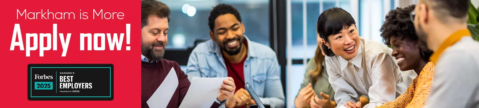 People smiling around a desk. Text reads, "Markham is more. Apply now." Forbes 2025, Canada's best employers award.